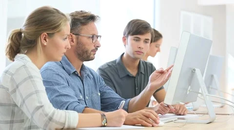 School instructor helping students with work project Stock Footage 56328579