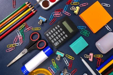 School items on the blue table. Back to school. Stock Photos