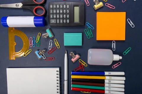 School items on the blue table. Back to school. Stock Photos