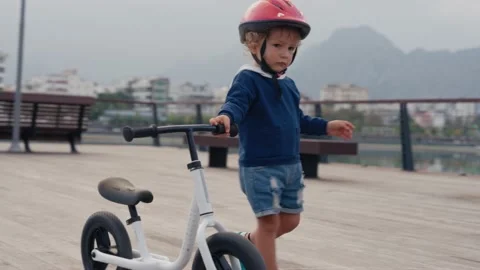 School kid boy, brother teaching happy litttle child cycling and having fun with Vídeo Stock 228010317