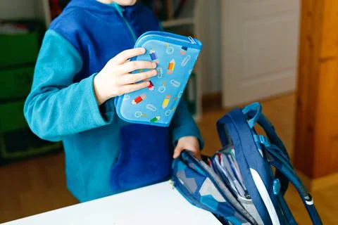 School kid boy getting ready in the morning for school. Healthy child filling Stock Photos