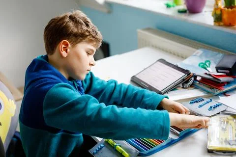School kid boy getting ready in the morning for school. Healthy child filling Stock Photos