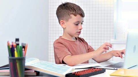School kid with computer having video conference chat with teacher  Stock Footage 278975176