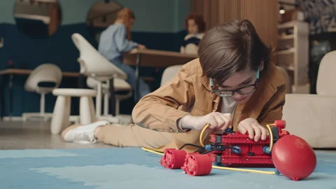 School Kid Constructing Robot while Classmates Drawing Video stock 153466037