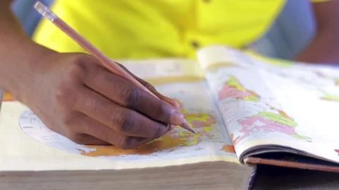 School kid pointing pencil in a book. Reading book	 Stock Footage 201316737