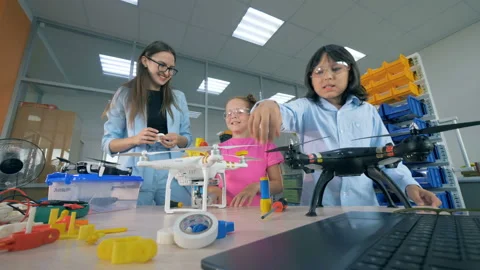 School kids explore drones, copters at technology class. Stock Footage 95034058
