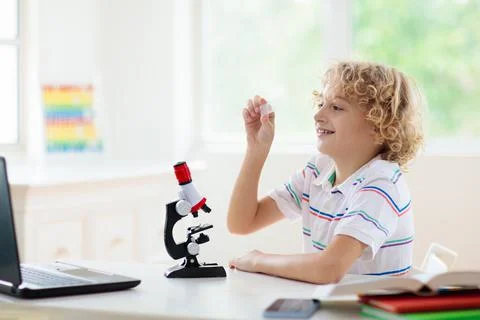 School kids with microscope. Science class. Stock Photos