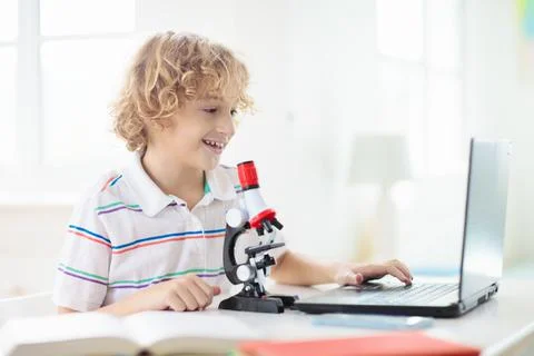 School kids with microscope. Science class. Stock-Fotos
