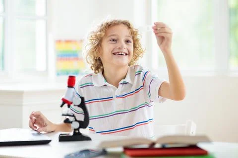 School kids with microscope. Science class. Stock Photos