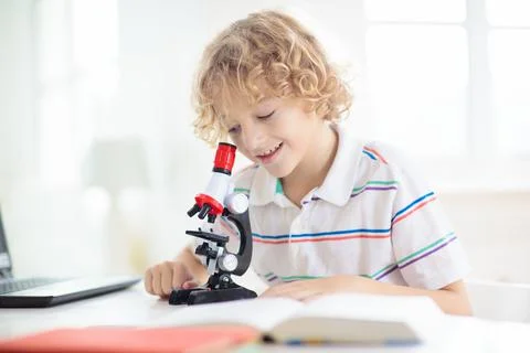 School kids with microscope. Science class. Stock Photos