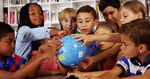 School kids studying globe in library Stock Footage
