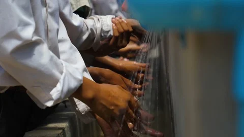 School Kids Washing Hands From Well Pump Slow Motion Stock Footage