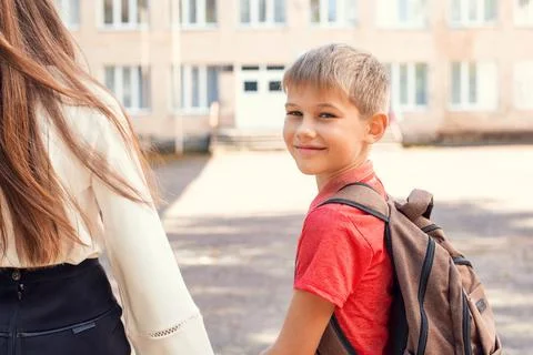School learner going to school with his mother Stock Photos