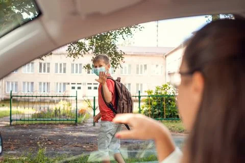 School learner going to school in the morning wearing protective mask Stock Photos