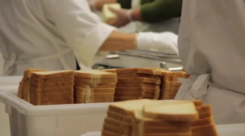 School lunch assembly line workers prepare sandwiches with bread 動画素材 41612289