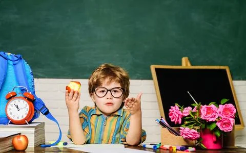School lunch. Child sitting at table and eats healthy food during break at .. Stock Photos