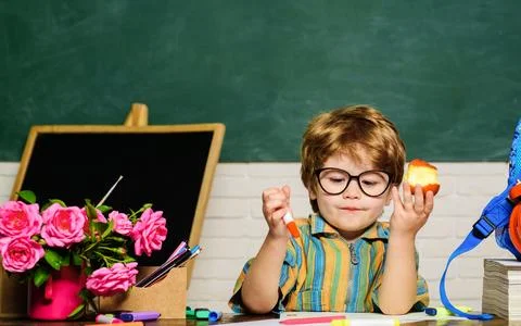 School lunch. Child sitting at table and eats healthy food during break at sc Stock Photos
