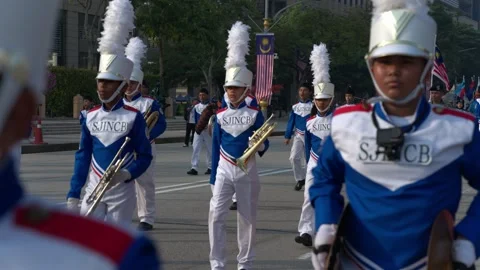 School marching band performing with brass instruments and drums in blue and Stock Footage 346355539