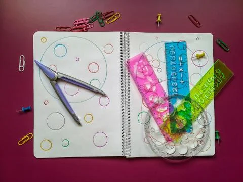 School material in composition on purple background Stock Photos