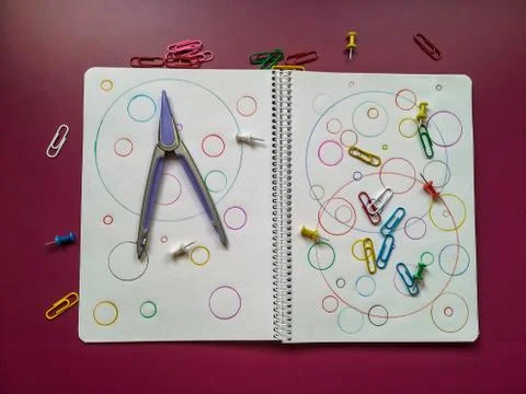 School material in composition on purple background Stock Photos