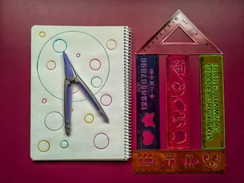 School material in composition on purple background Stock Photos