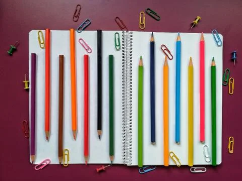 School material in composition on purple background Stock Photos