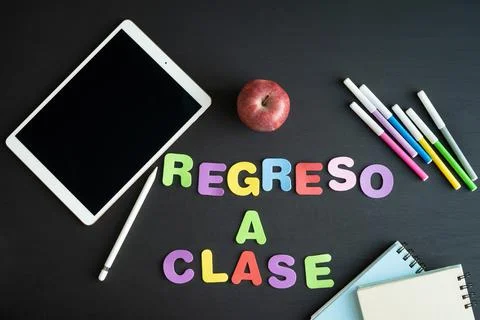 School materials with the phrase REGRESO A CLASE in Spanish. Copy space. Stock Photos