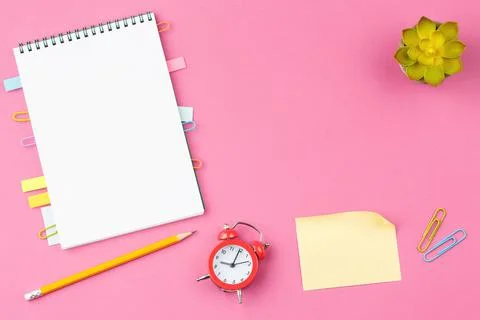 School notebook with alarm clock Stock Photos
