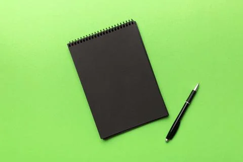 School notebook on a colored background, spiral black notepad on a table Top  Stock Photos