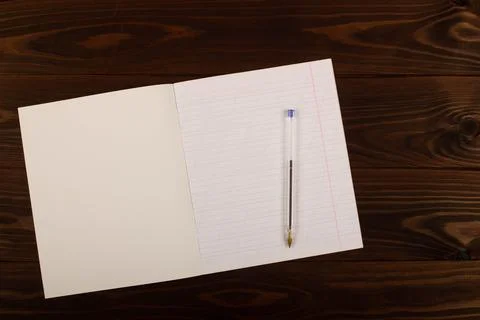 School notebook with lines and pen on the table. School supplies. Copy space Stock Photos