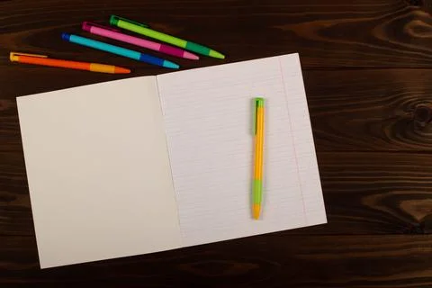 School notebook with lines and pens on the table. School supplies. Copy space Stock Photos
