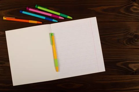 School notebook with lines and pens on the table. School supplies. Copy space Stock Photos