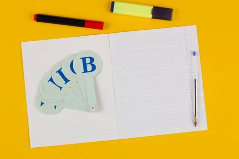 School notebook on a yellow background with copy space for text, colorful Stock Photos
