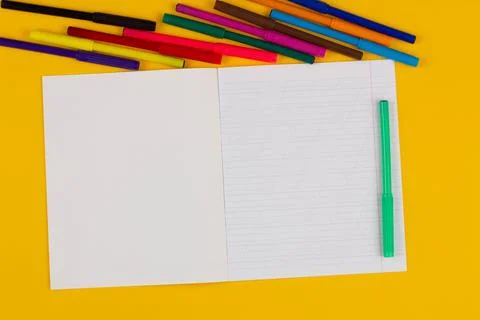 School notebook on a yellow background with copy space for text, colorful Stock Photos
