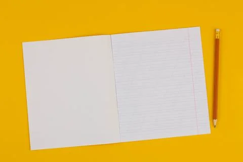 School notebook on a yellow background with copy space for text and pencil Stock Photos