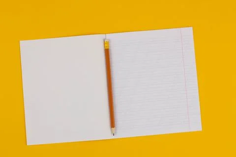 School notebook on a yellow background with copy space for text and pencil Stock Photos
