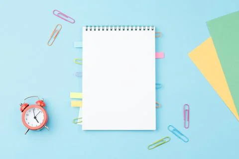 School notepad with stationery on blue background. Stock Photos