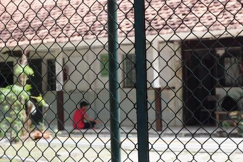 School Renovation Seen Through Chain Fence Stock Photos