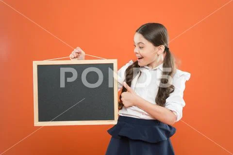 School schedule information. School girl cute pupil hold blackboard copy space Stock Photos