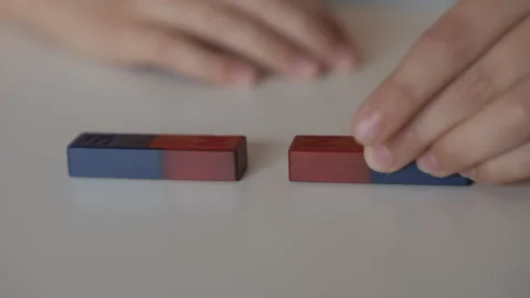School Science Educational Experiment With Magnets. Child Hands Moves Two M.. Stock Footage 327595276