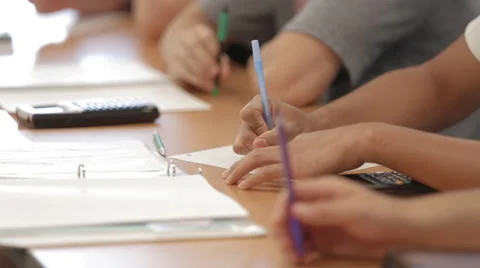 School Shots - Row of Students (diverse group)  in class doing work Stock Footage 54593062