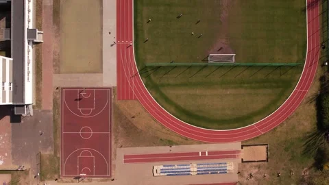 School Soccer Field and Running Track: Overhead Aerial View with People Stock Footage 307067334