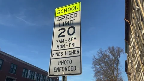 School Speed Limit 20mph 7AM - 6PM Mon-Fri Fines Higher Photo Enforced Sign.. Stock Footage 228690107