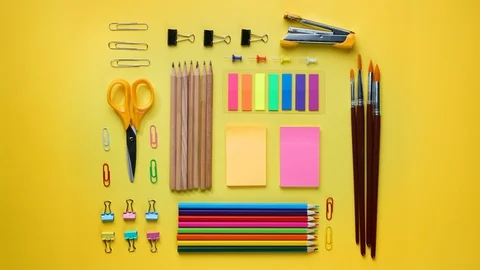 School Stationary Flat Lay on Yellow Background Time Lapse 4K Stock Footage 93624941