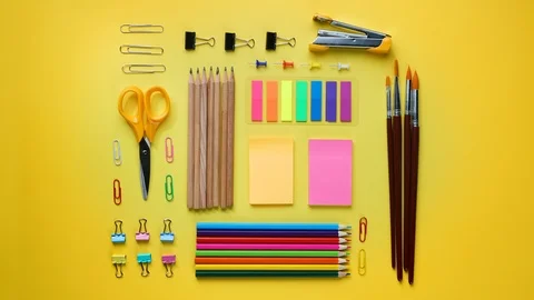 School Stationary Flat Lay on Yellow Background Time Lapse 4K Stock Footage 93625359