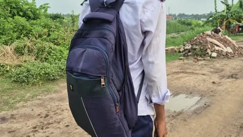 School Student Backpack Back View On Rural Mud Road Stock Footage 337597488