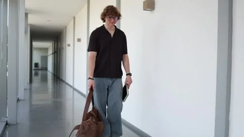 School student walking to class with backpack Stock Footage 338277604