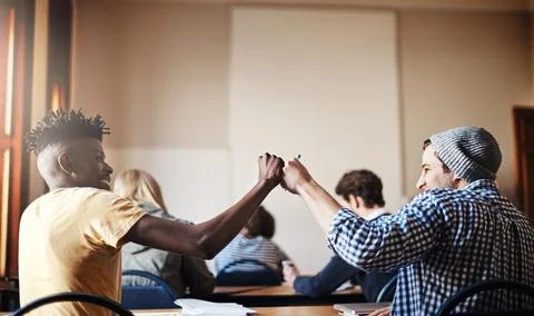 School, students and men in class fist bump to success for assignment, project Stock Photos