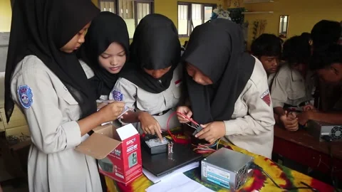 School students in Java, Indonesia, practice measuring DC electrical power 스톡 동영상 330145459