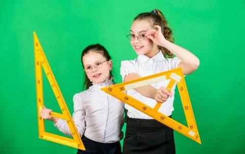 School students learning geometry. Pupil cute girls with big rulers. small girls Foto stock